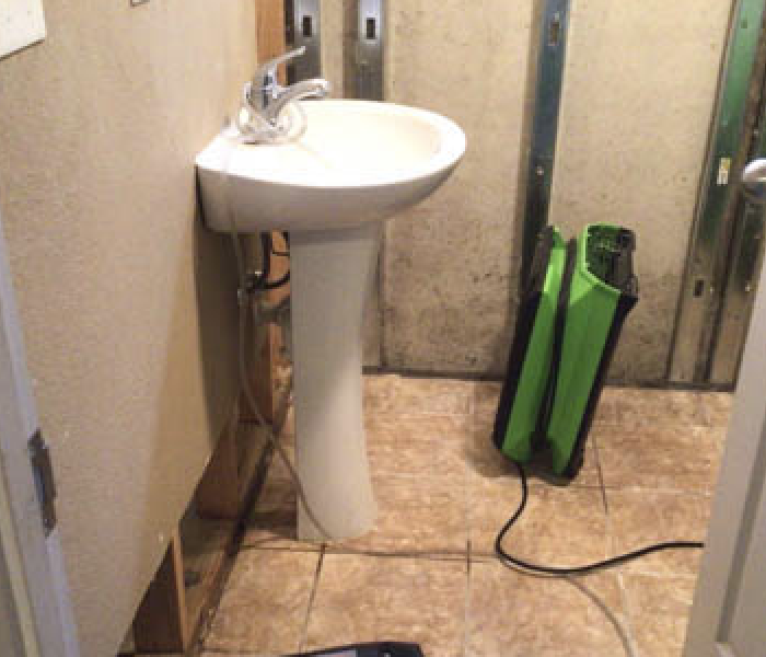 SERVPRO equipment drying a water damaged bathroom